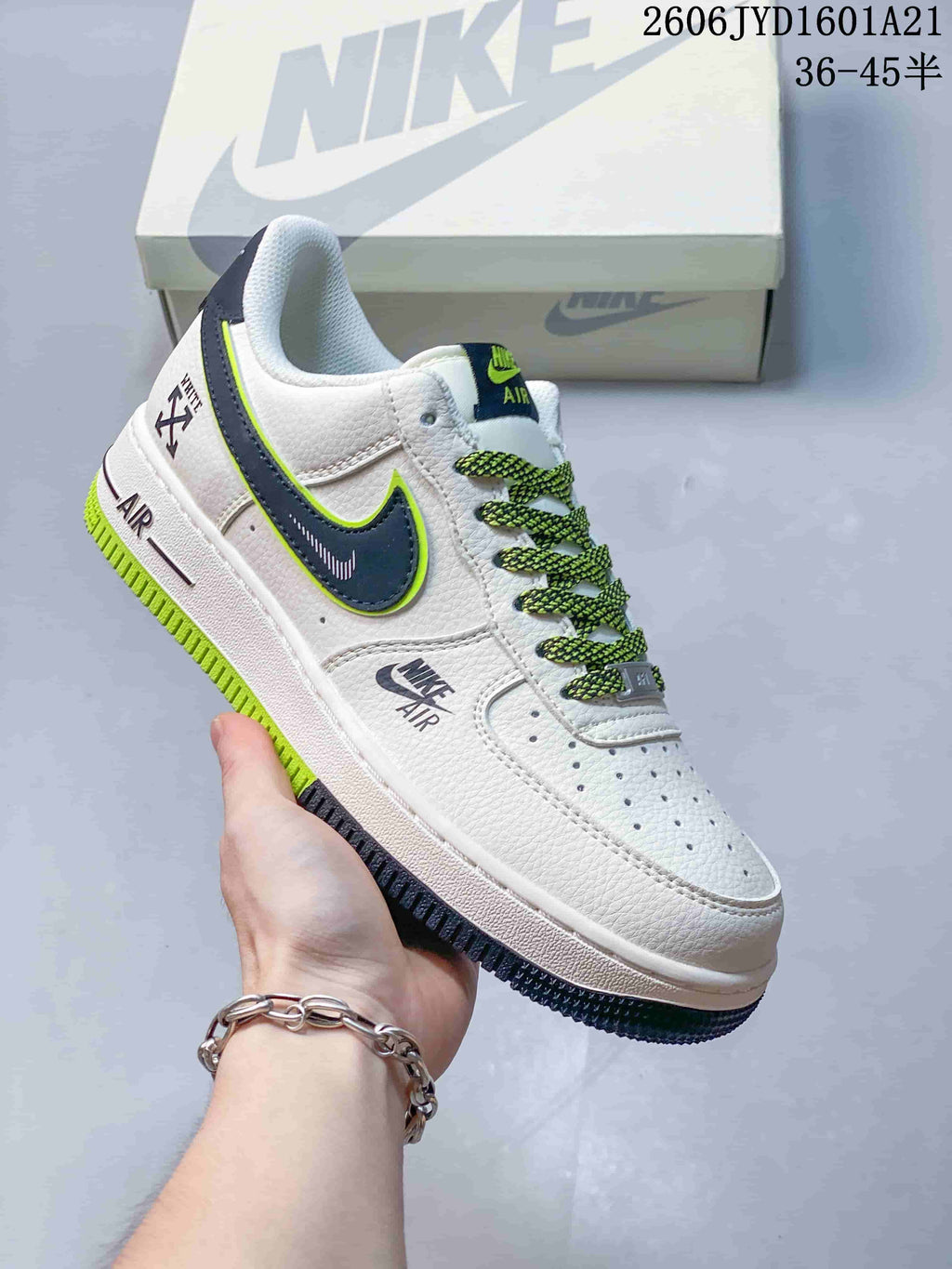 Angled side view highlighting the white upper and contrasting navy and lime details