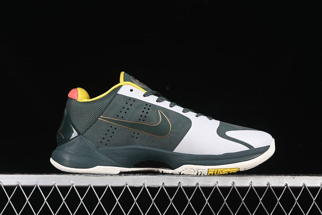 Side profile of the shoe with a dark green upper, white panels, and yellow outsole accent