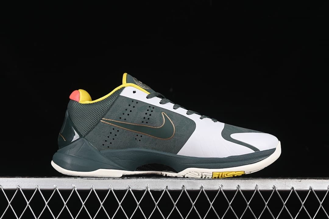 Side profile of the shoe with a dark green upper, white panels, and yellow outsole accent