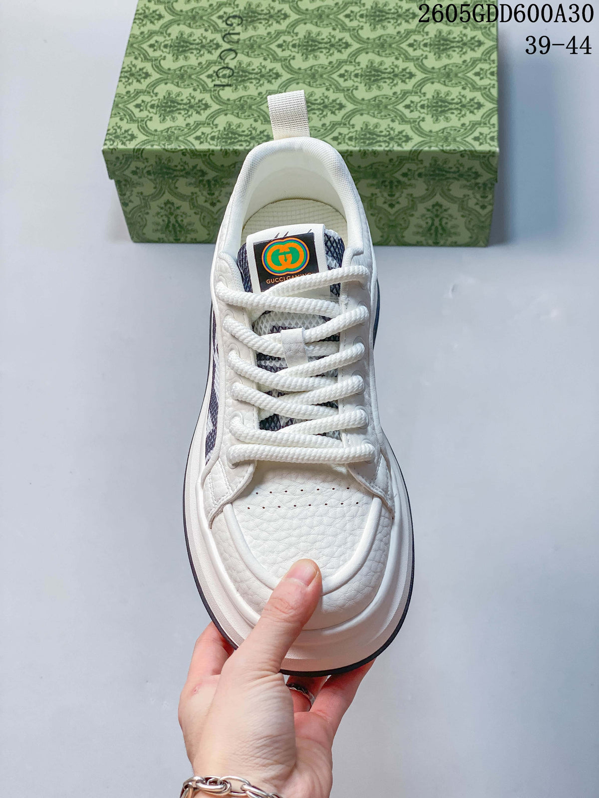 Top view of the white lace-up sneaker showing its perforated toe and tongue label.