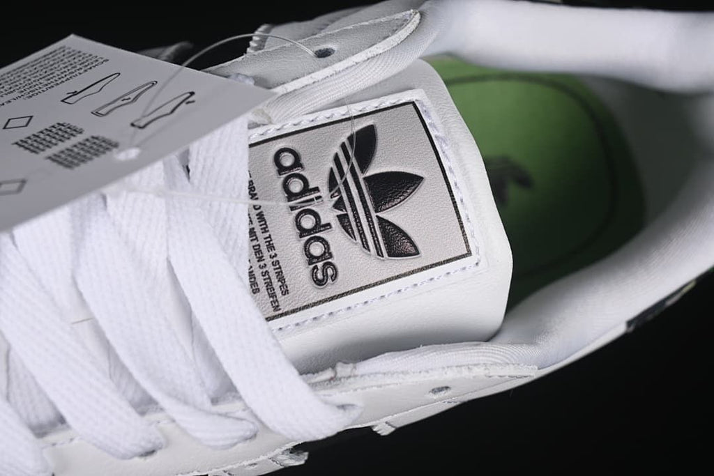 Close-up of the tongue label, white laces, and green insole
