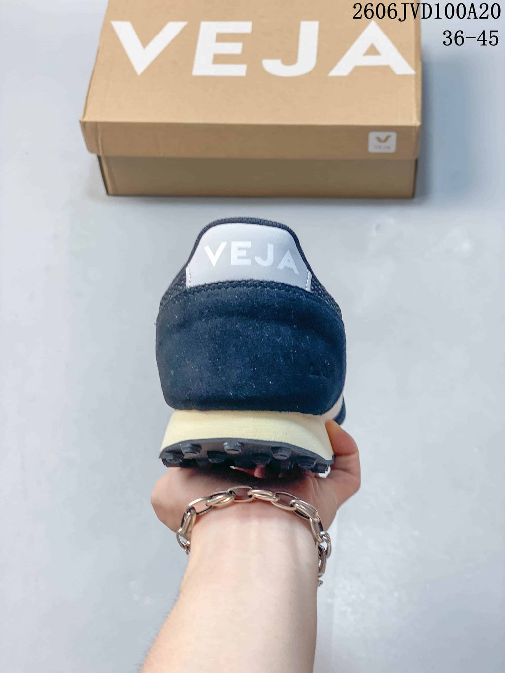 Rear view of a navy Veja sneaker showing the heel and light-colored midsole.