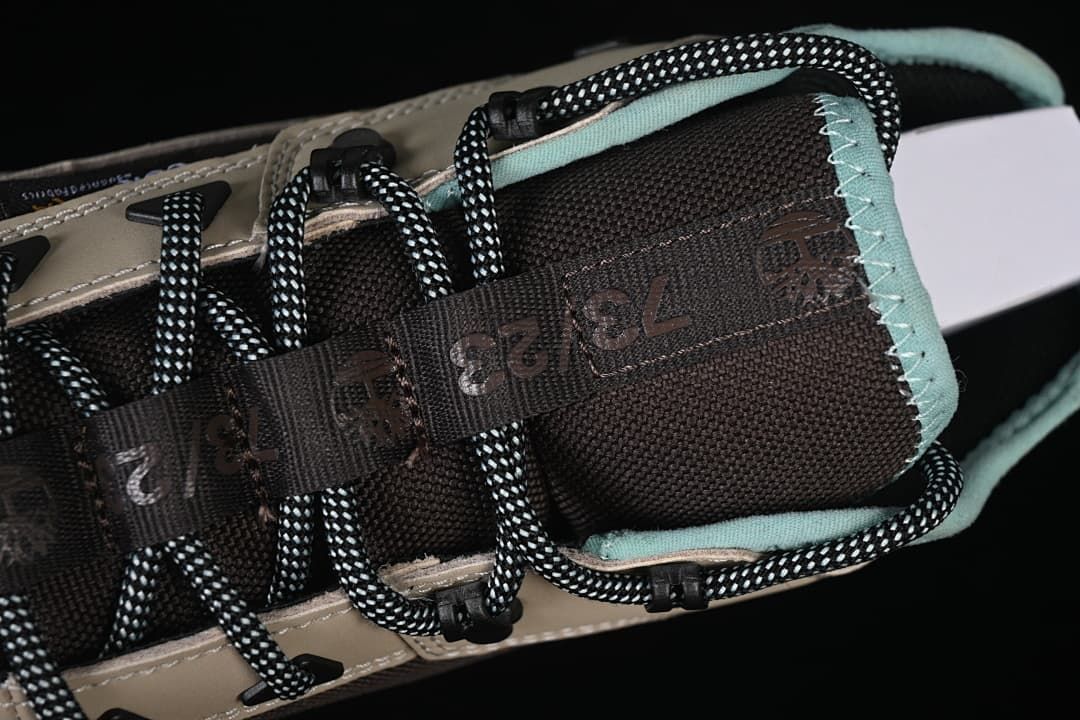 Top close-up of the padded tongue, collar, and patterned laces