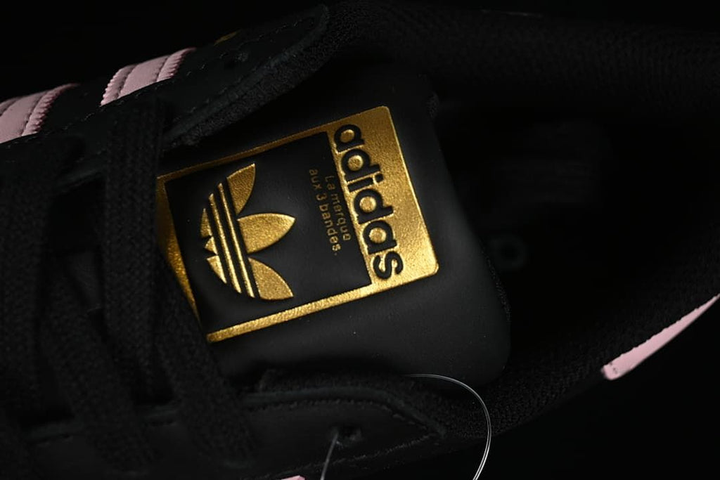 Close-up of the tongue with a gold-tone Adidas label