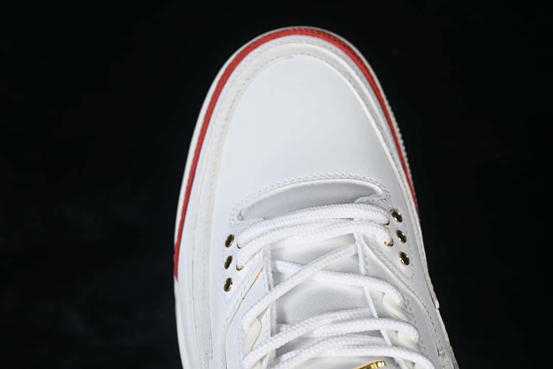 Top-down close-up of the white toe and lace area with gold-tone eyelets