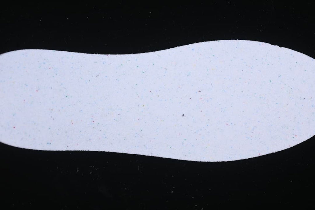 Light-colored shoe insert shown against a dark background