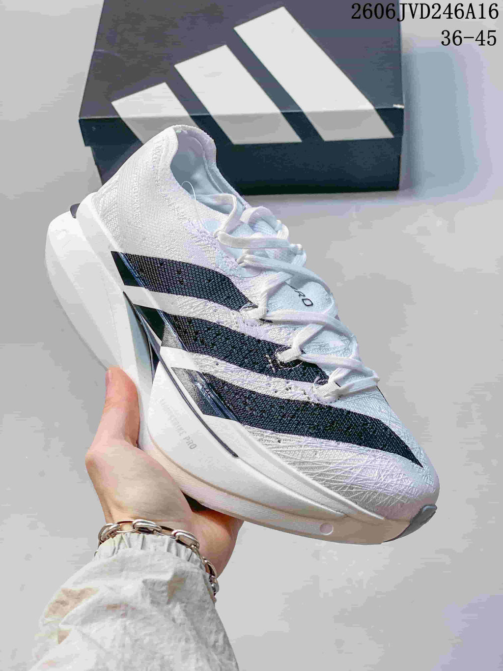 Angled side view of the white and black Adidas running shoe
