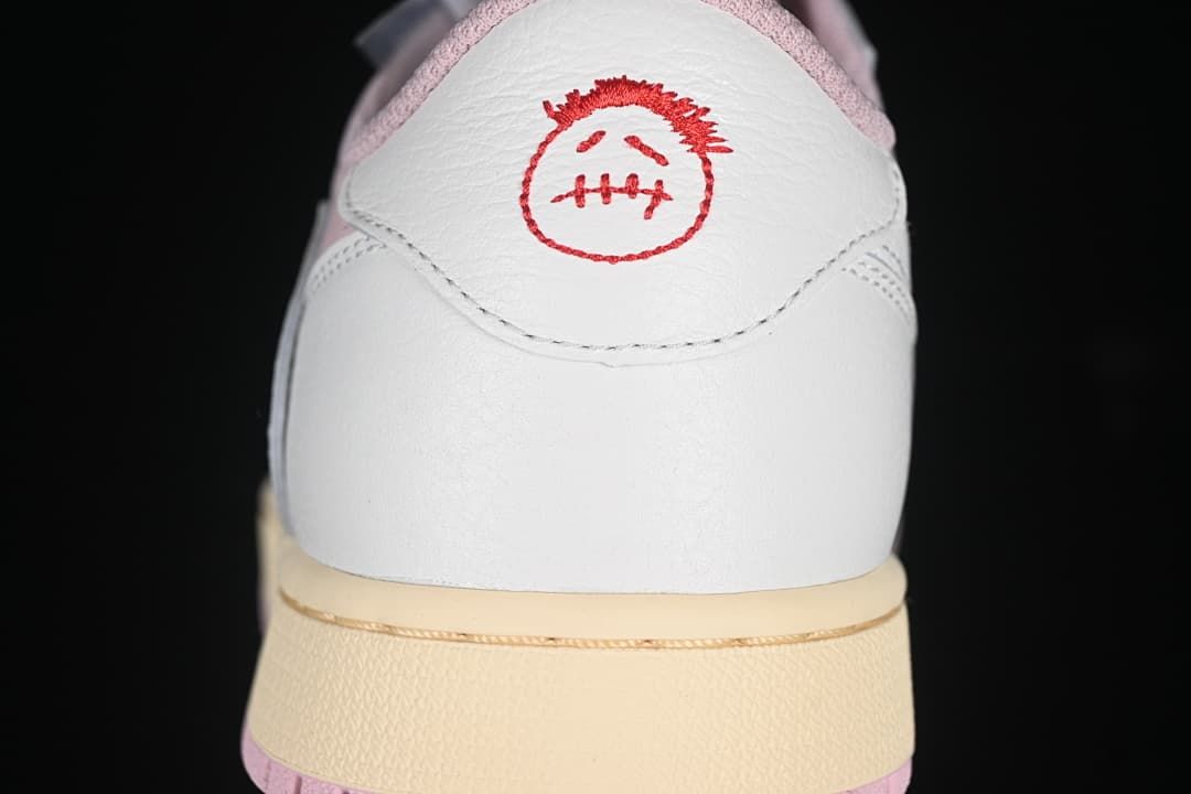 Rear view showing white heel panels and red embroidered graphics