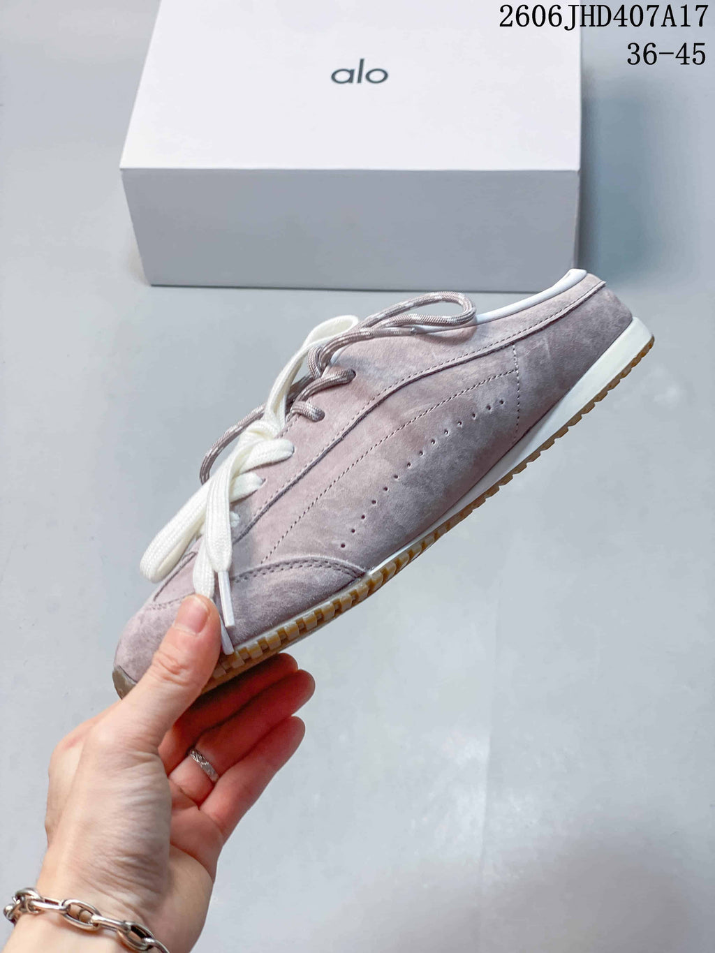 Side profile showing the mauve upper and perforated detailing