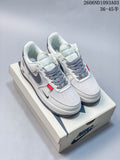 Pair of white and grey Nike Air Force 1 '07 Low sneakers with patterned laces and red accents