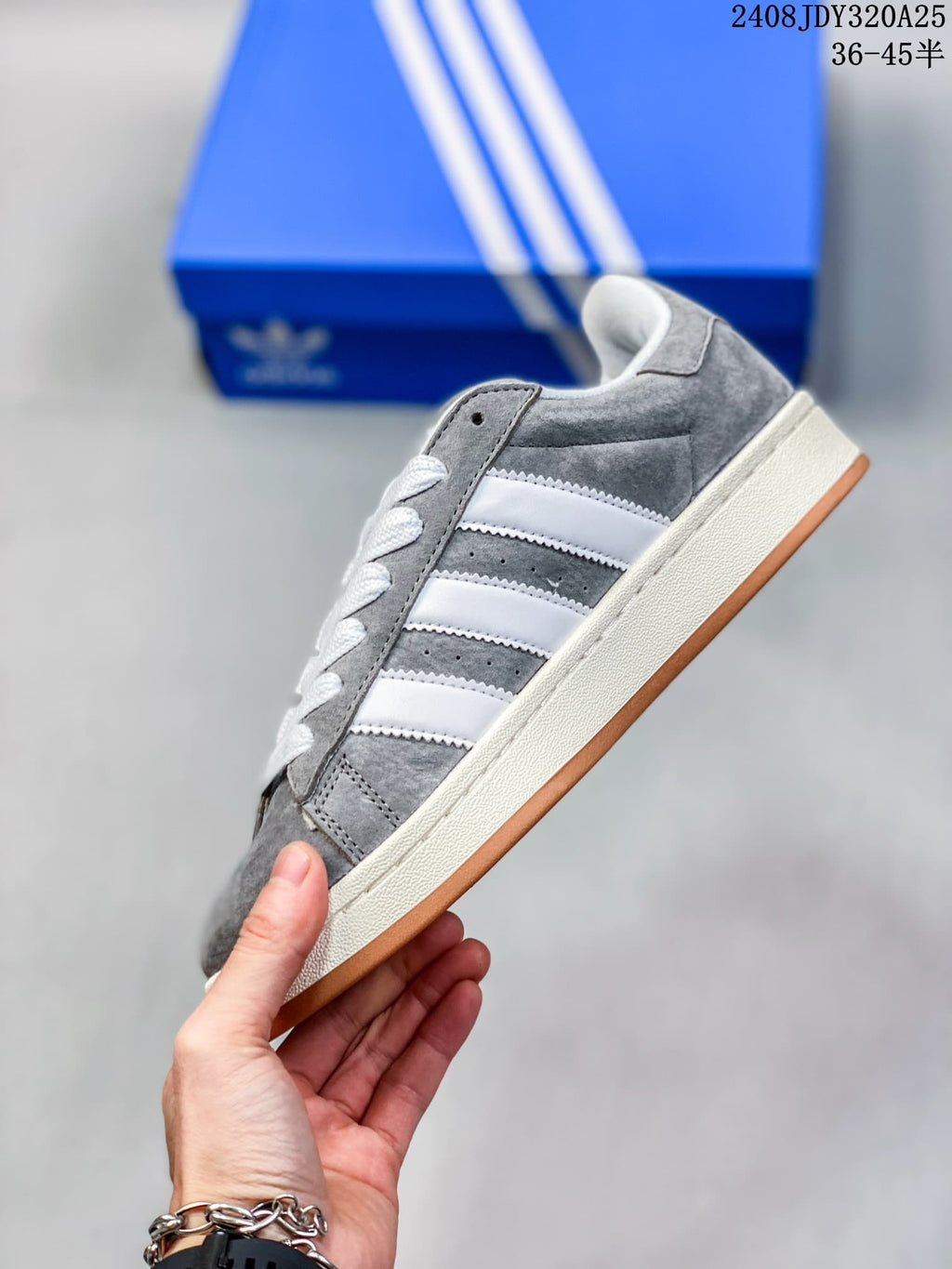 Side view of the grey Campus sneaker with white three-stripe detailing.