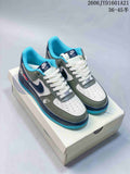 Pair of white, muted green, navy, and bright blue low-top sneakers shown from above.