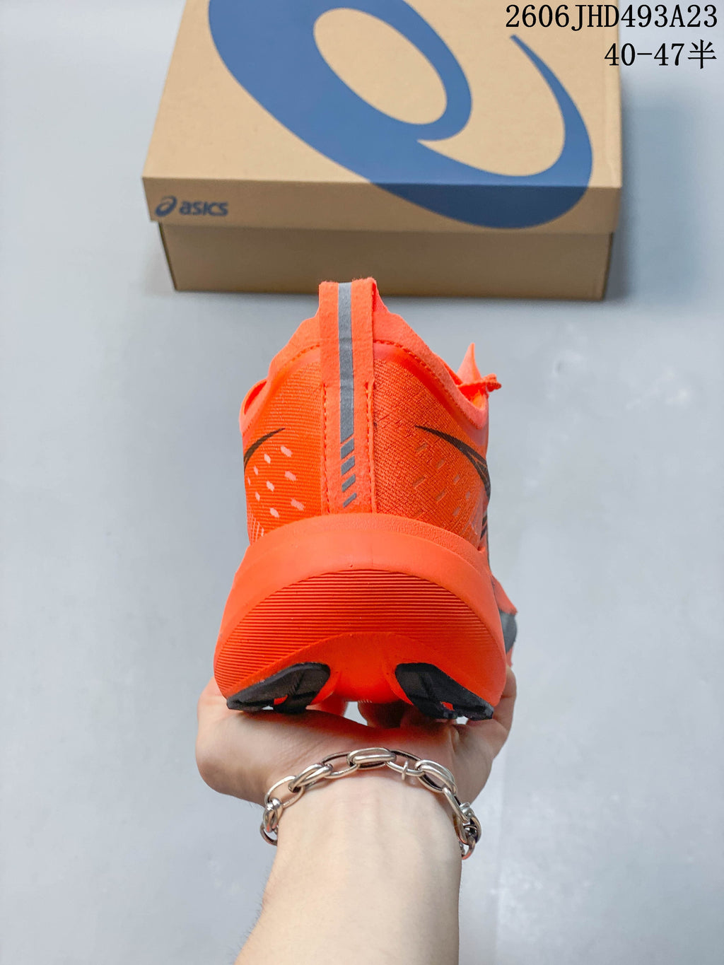 Rear view of an orange running shoe with a sculpted heel