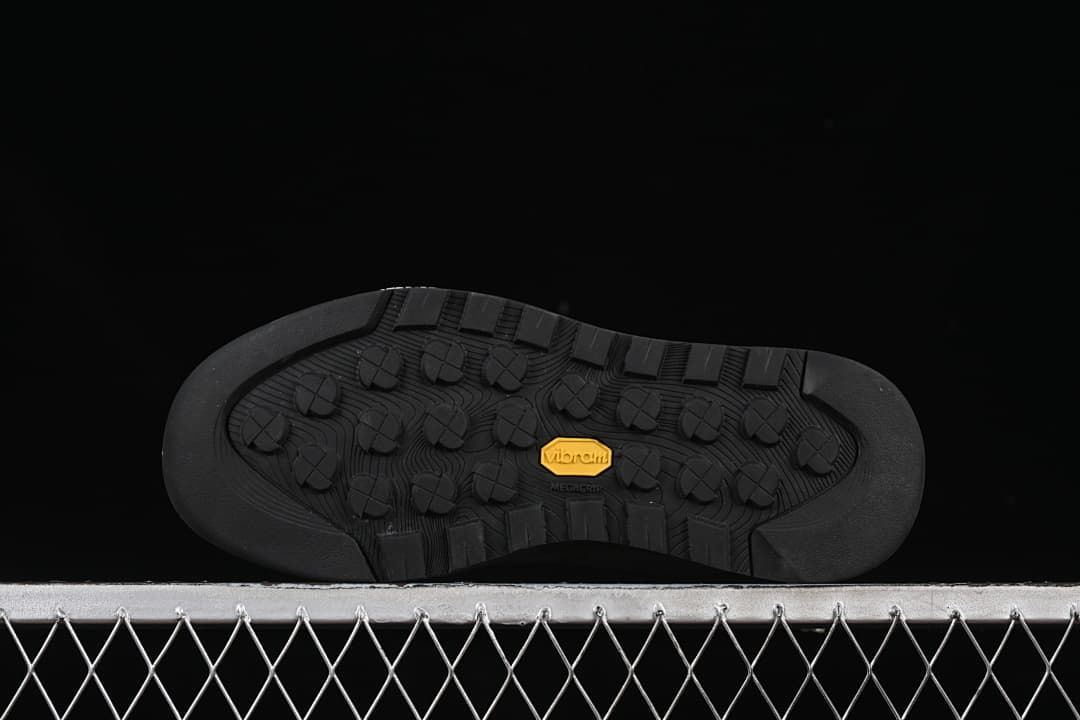 Underside of the sneaker with lugged outsole and Vibram mark