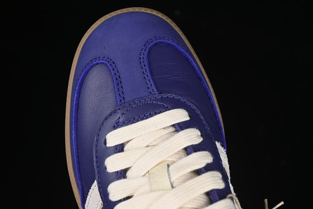 Top-down view of the purple toe and cream-colored laces