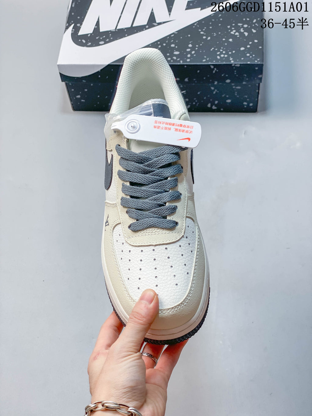 Top view of a Nike Air Force 1 '07 LV8 sneaker with a perforated toe and gray-blue laces.