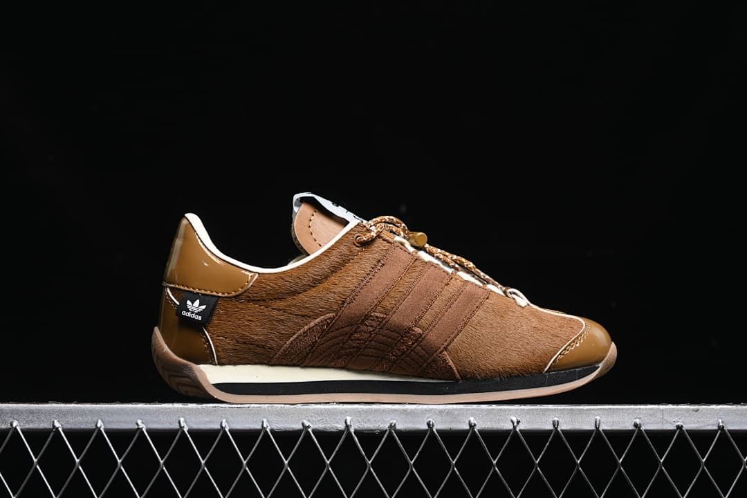 Side profile showing the layered brown upper and heel branding