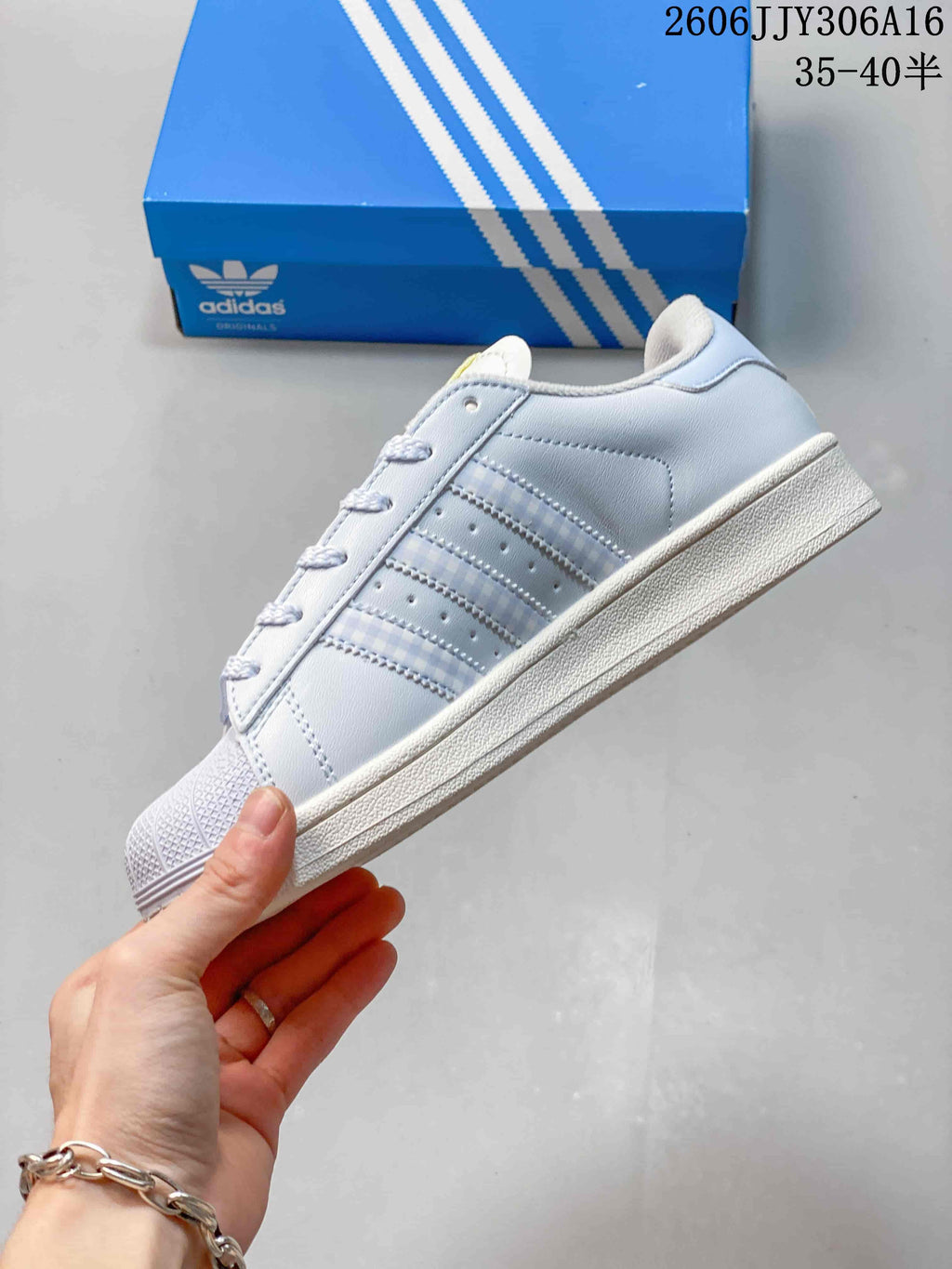 Side profile showing the three-stripe detail and shell toe