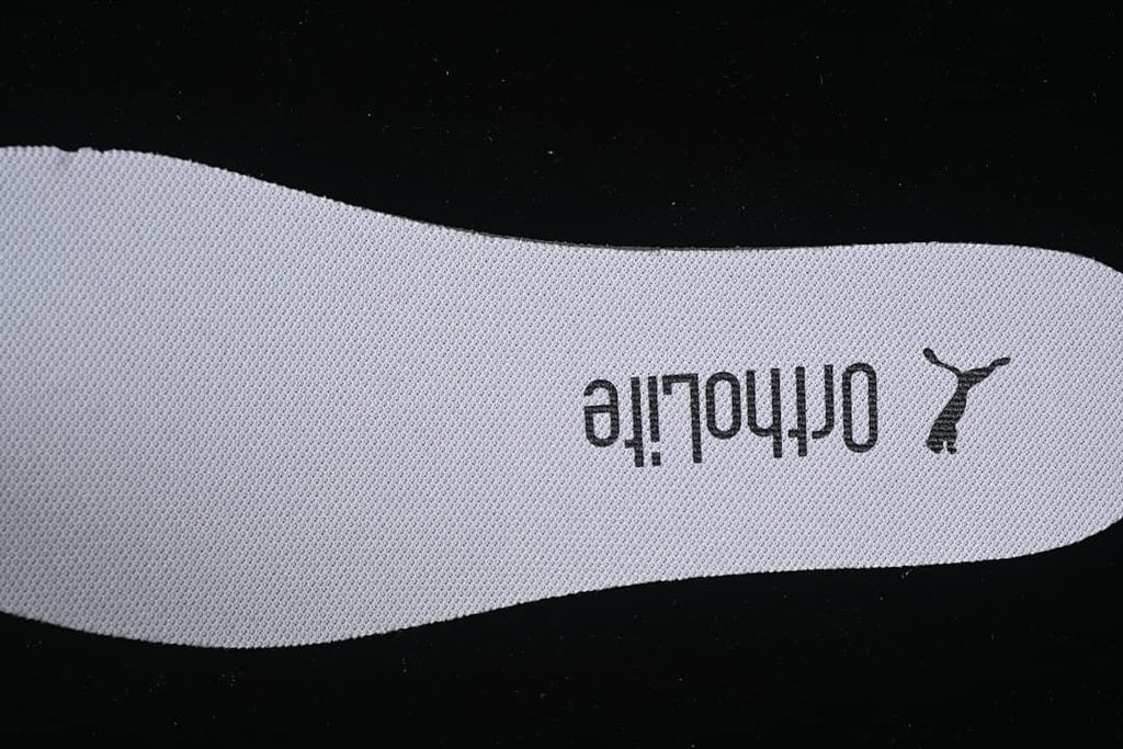 Close-up of a textured shoe insole marked Ortholite and Puma.