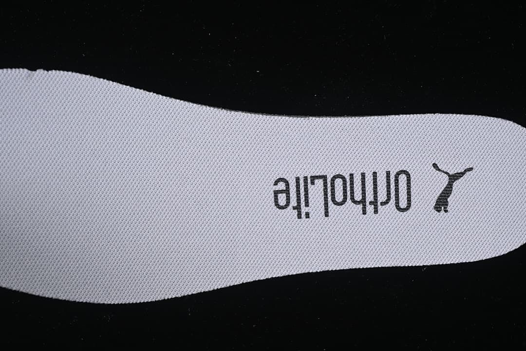 Close-up of a textured shoe insole marked Ortholite and Puma.