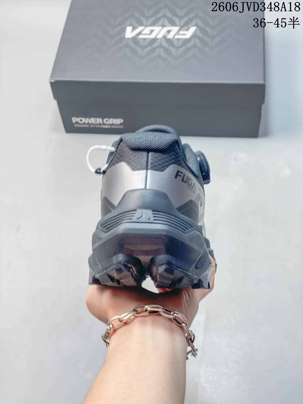 Rear view showing the heel and outsole of the gray trail shoe