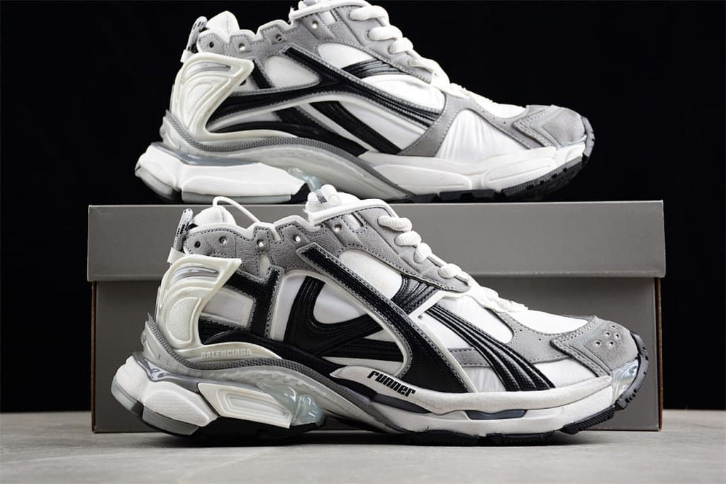 Two side views of the Runner sneakers displayed with a shoe box