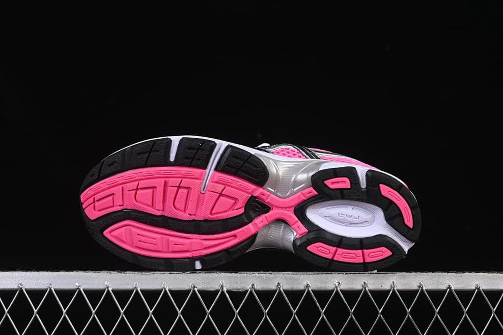 Underside view showing pink, black, and white tread sections.