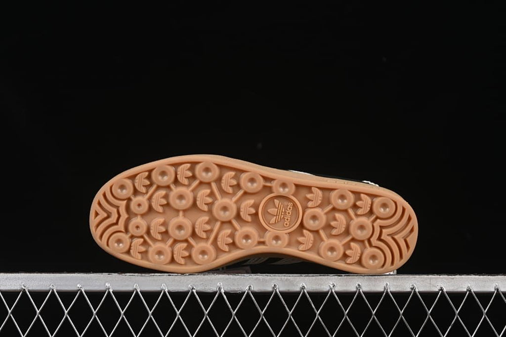 Underside view of the gum-colored outsole with patterned tread.