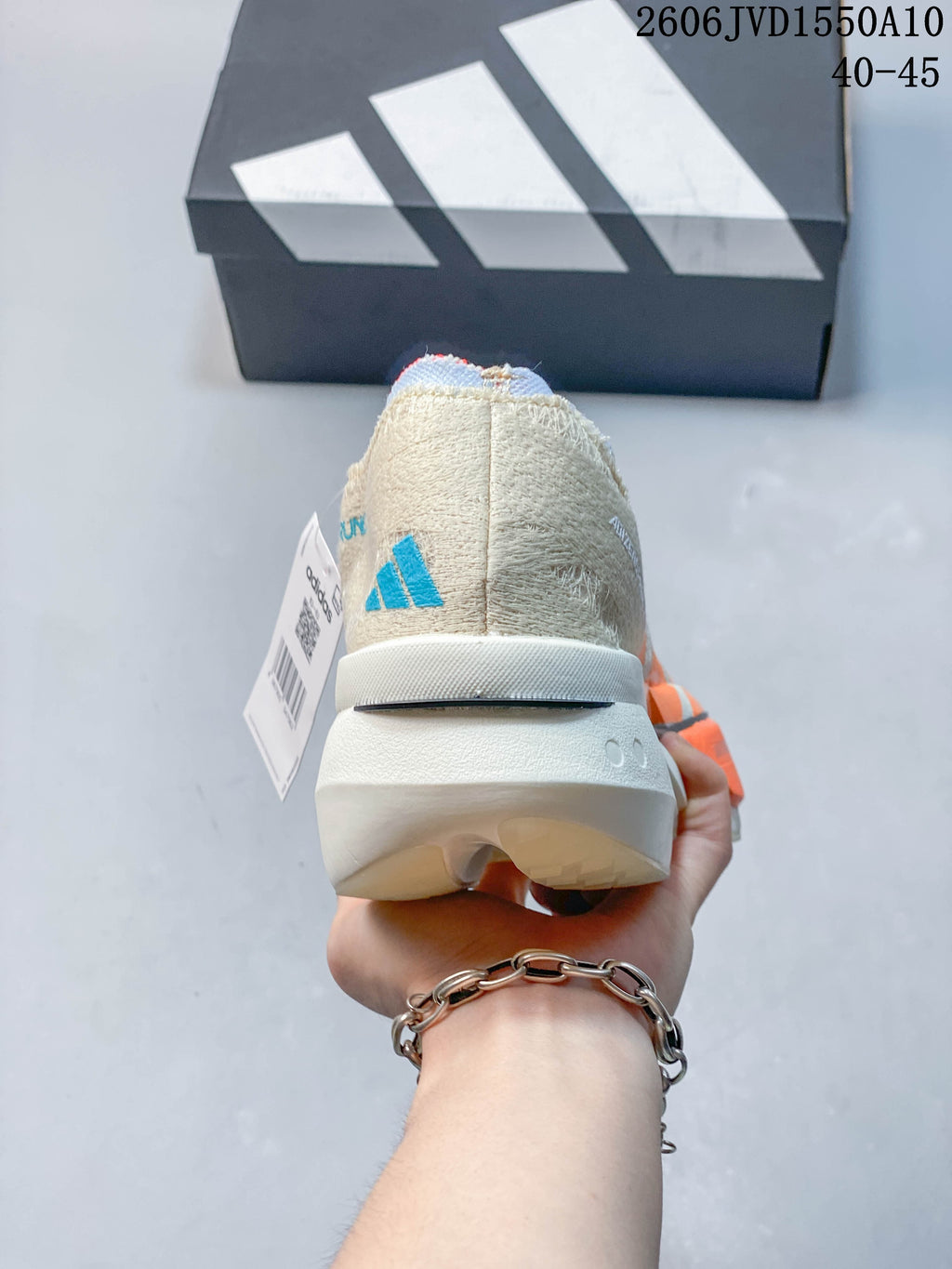 Rear view of the cream running shoe showing the heel and sculpted sole.