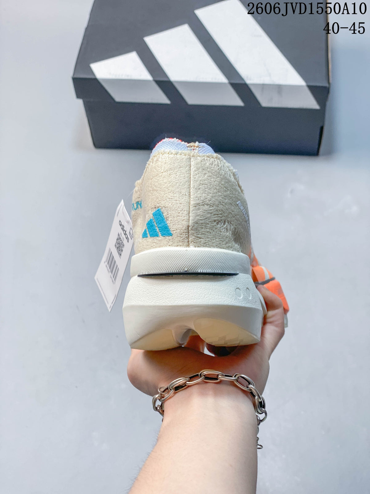 Rear view of the cream running shoe showing the heel and sculpted sole.