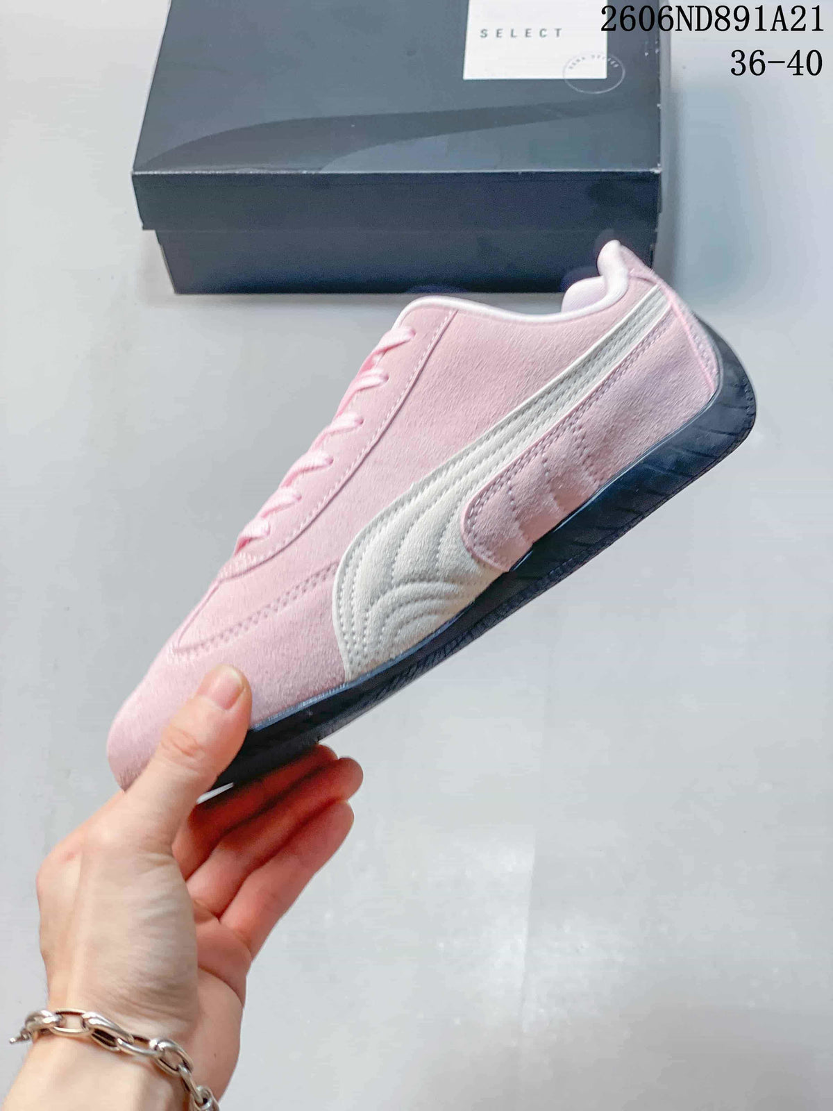 Side profile of a pink Puma Speedcat OG sneaker with a light-colored Formstrip