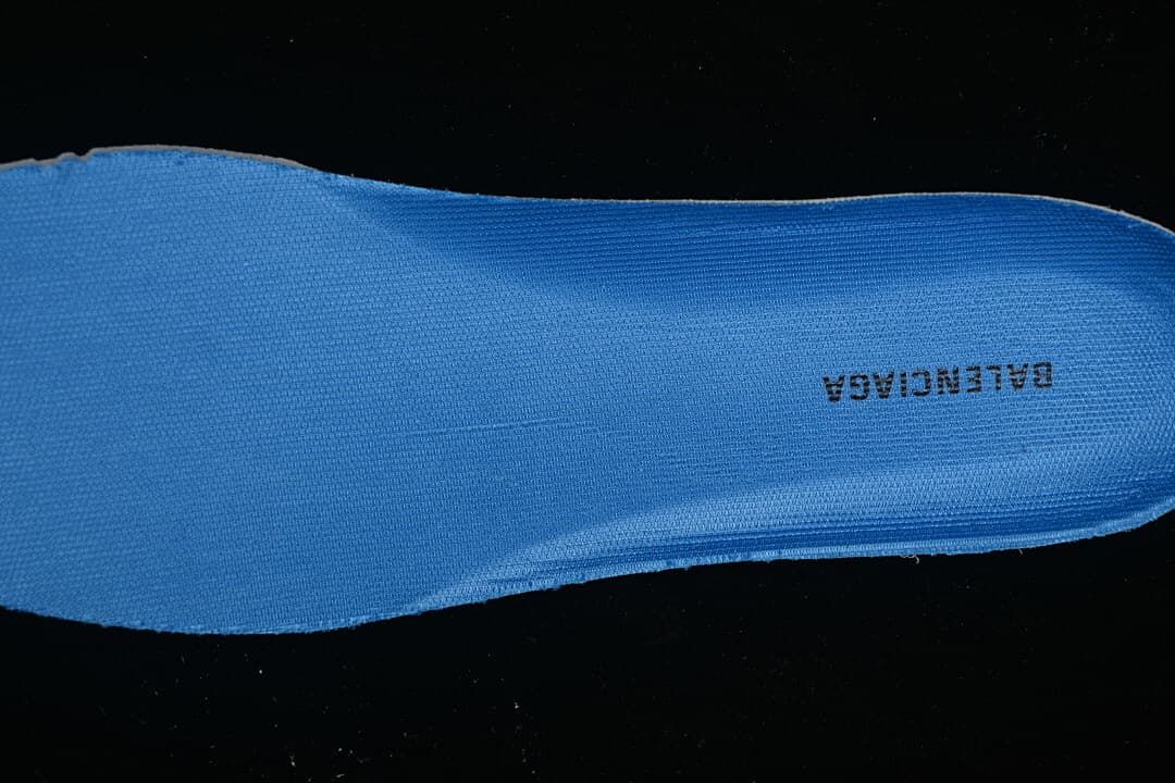 Close-up of a blue shoe insert with branding