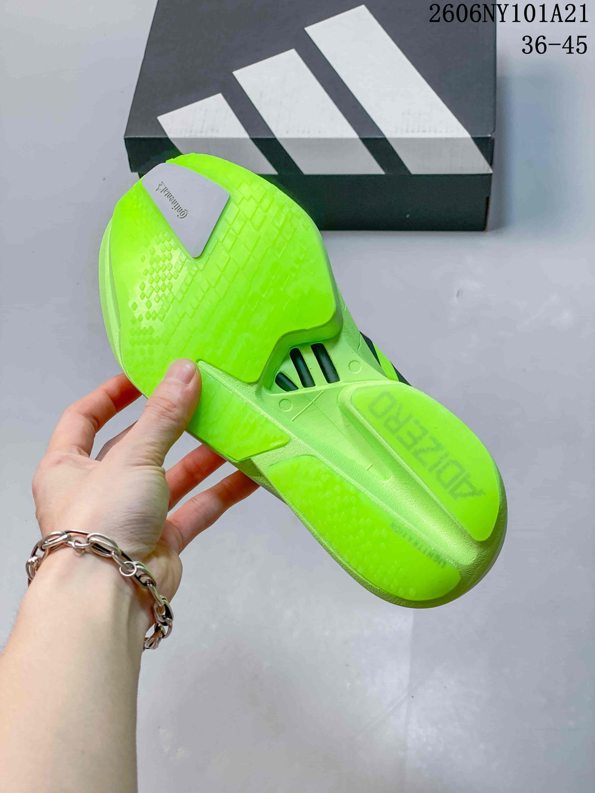 Close-up of the neon yellow outsole with textured tread and a shoebox in the background.