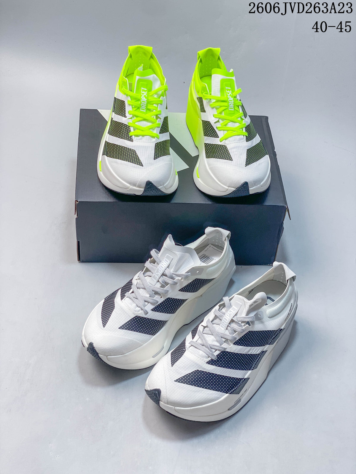 Adizero Dropset Elite shoes shown in white and neon yellow-green colorways.