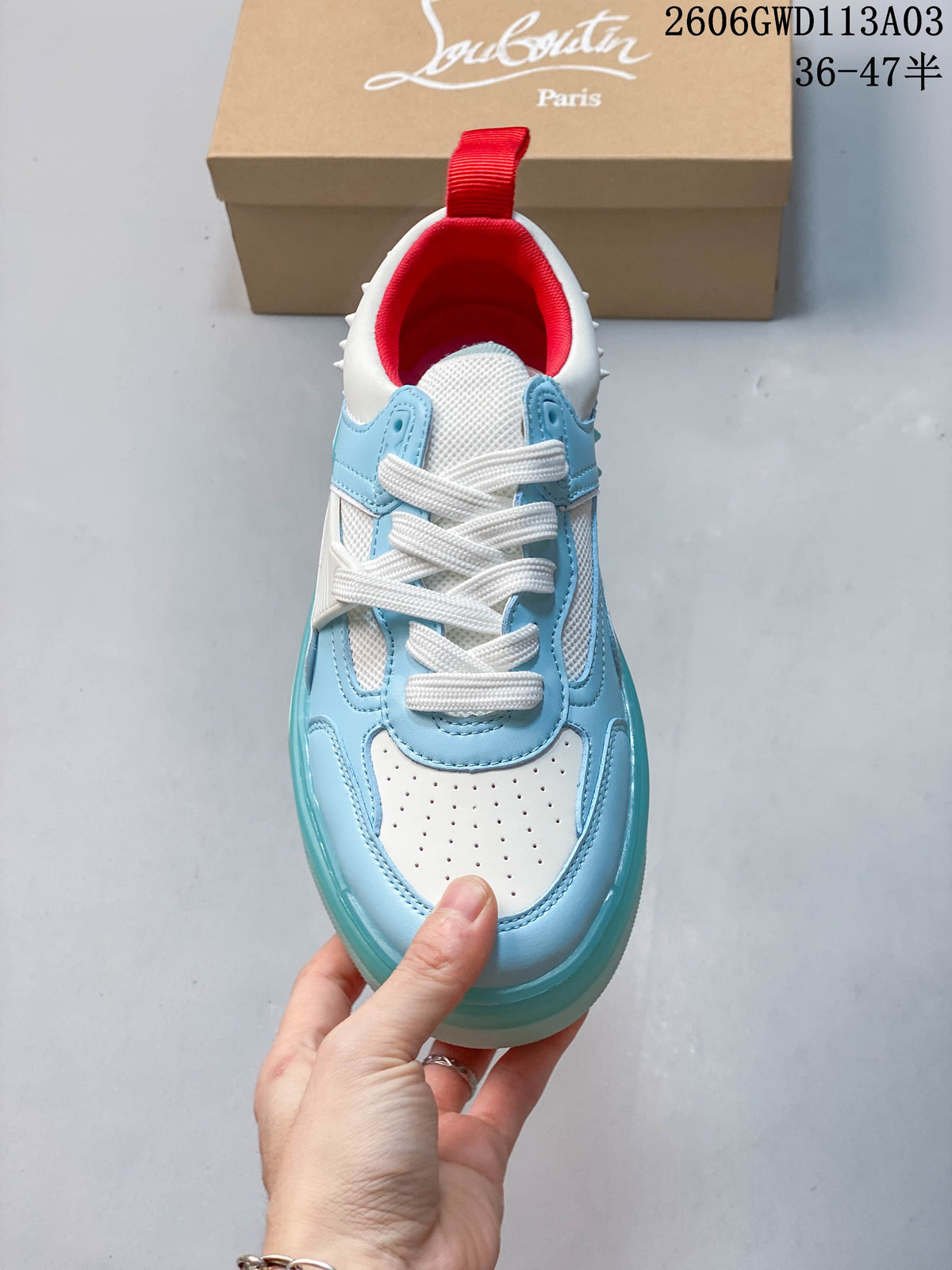Top view showing the white laces, perforated toe panel, and red lining
