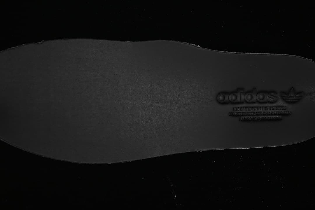 Close-up of a dark insole with embossed branding