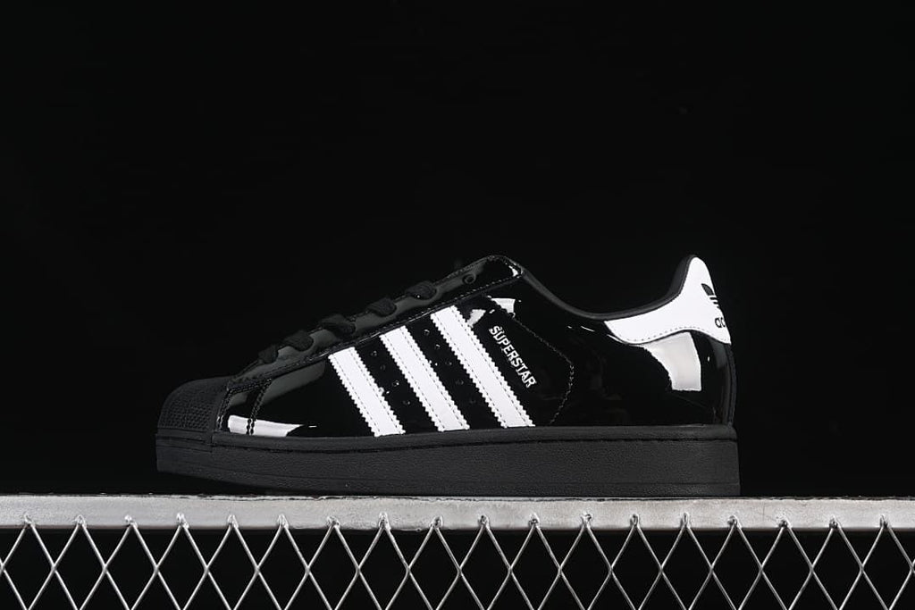Side profile of the black adidas Superstar II with white stripes