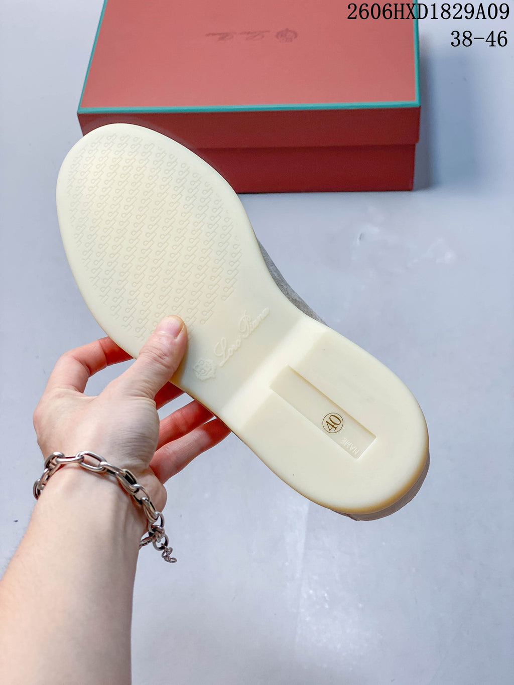 Underside of a loafer showing a pale patterned sole and lettering