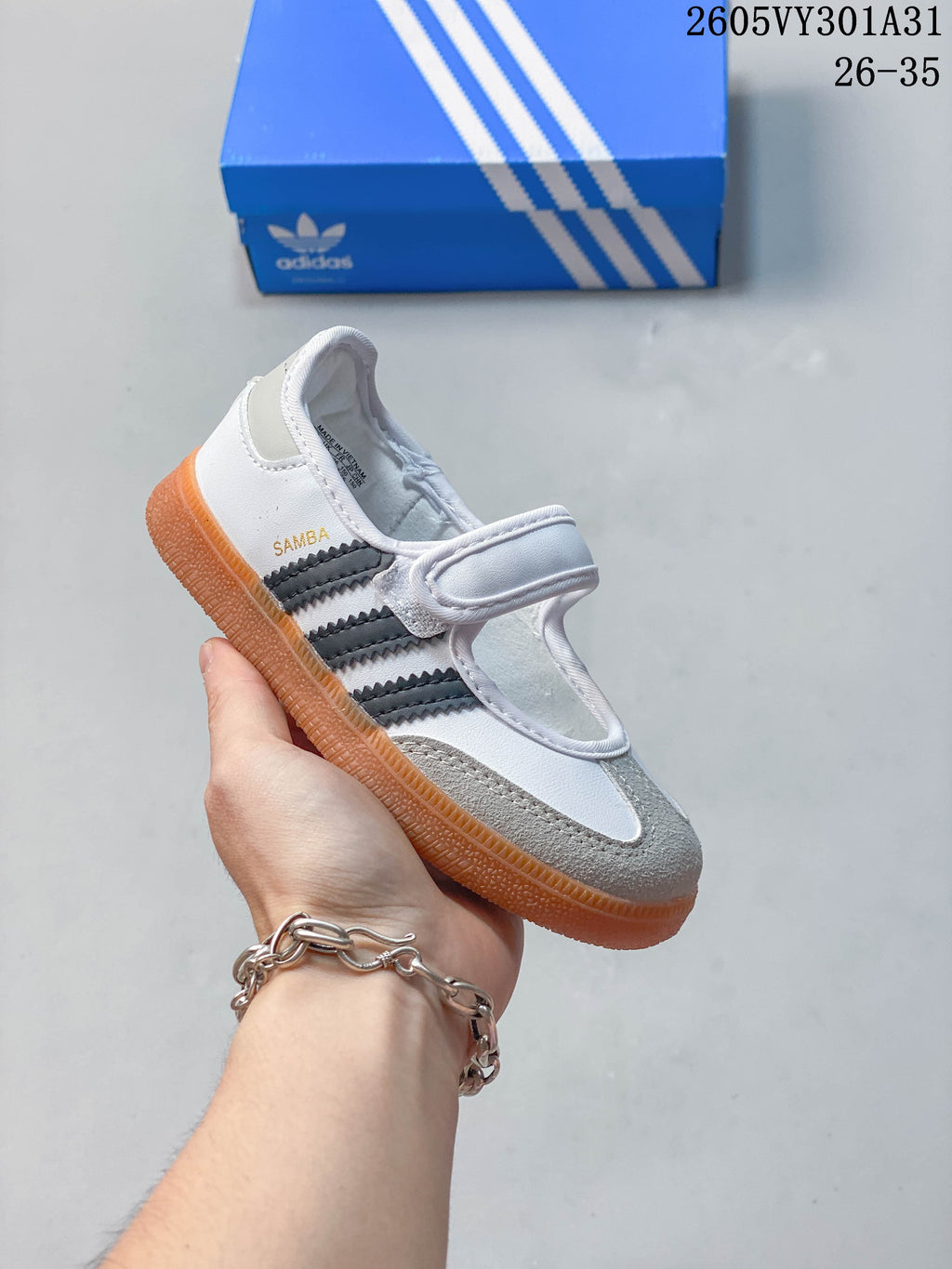 White kids’ Samba Jane shoe with dark gray side stripes and gray toe detail