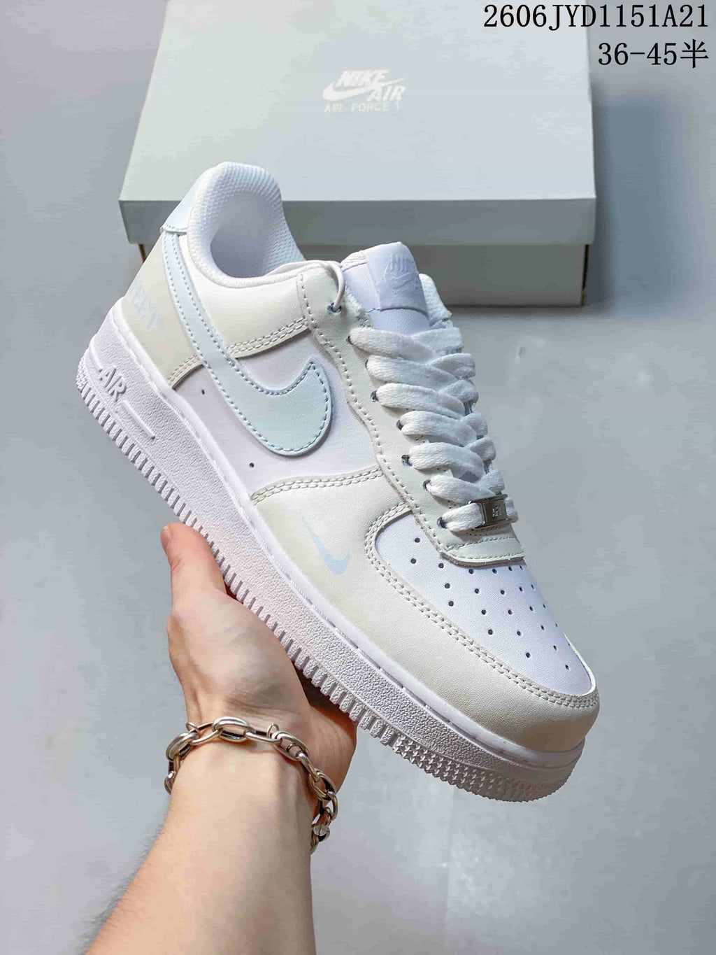 Angled close-up of the white sneaker with a light gray Swoosh
