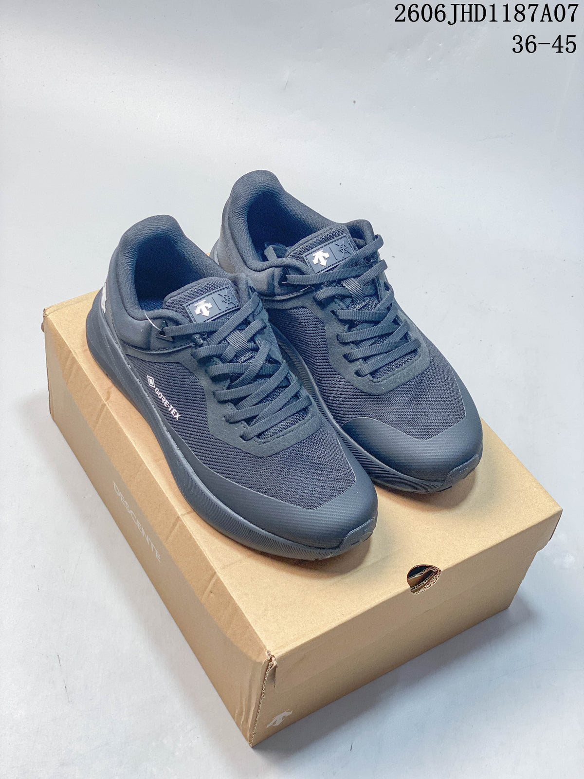 Pair of dark charcoal Descente Lavitate Trail Wire 3.0 low-top sneakers on a shoebox