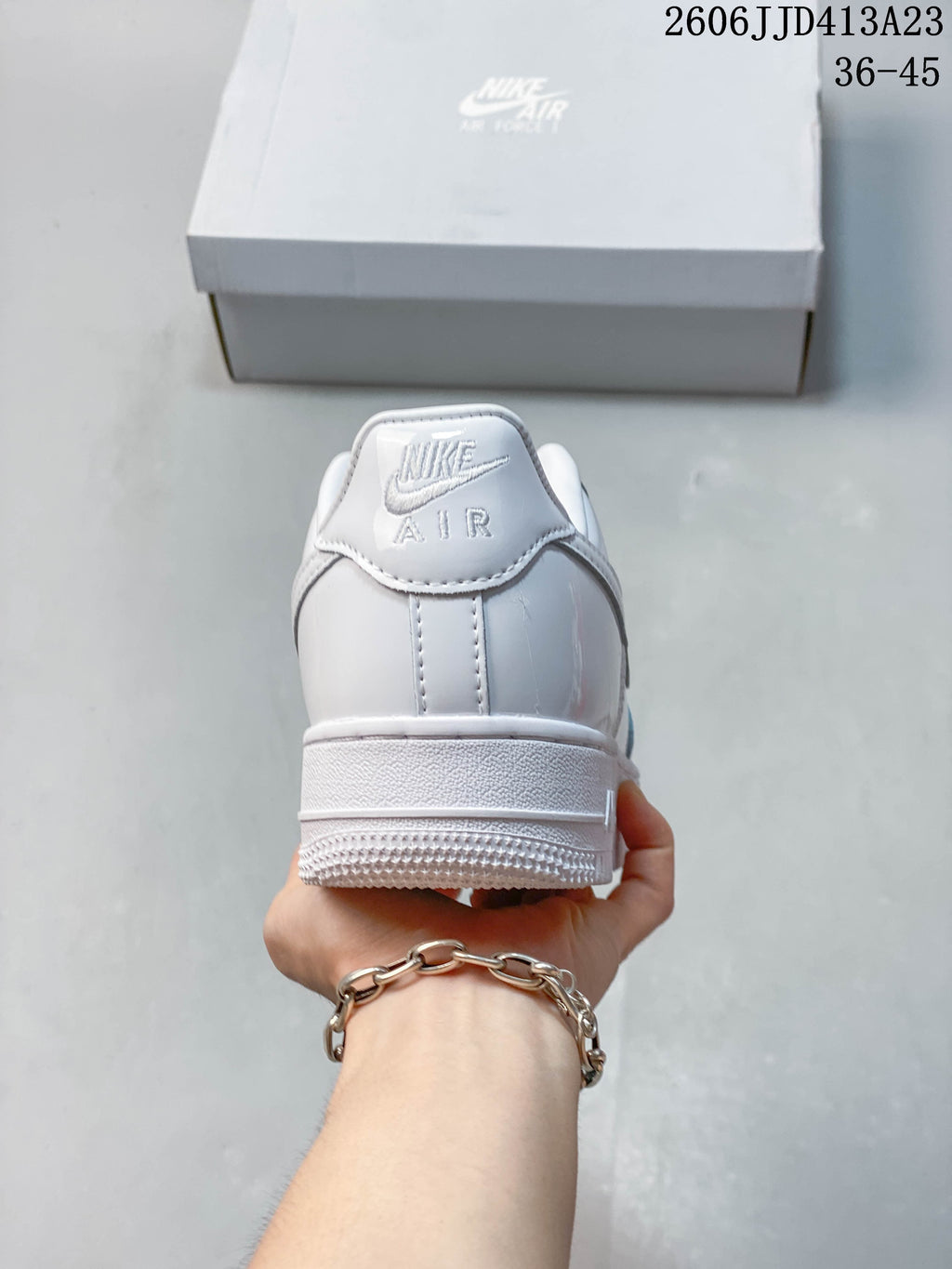 Rear view of the white sneaker showing heel branding and outsole