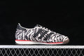 Side view of an adidas SL 72 OG sneaker with a black-and-cream animal-print upper and red midsole accent.