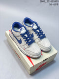 Pair of white and blue low-top Nike SB Dunk sneakers on a shoe box