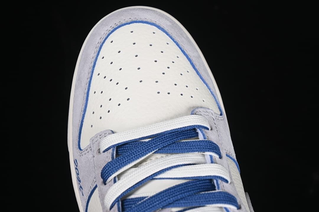 Top view of the perforated toe box and alternating blue and white laces