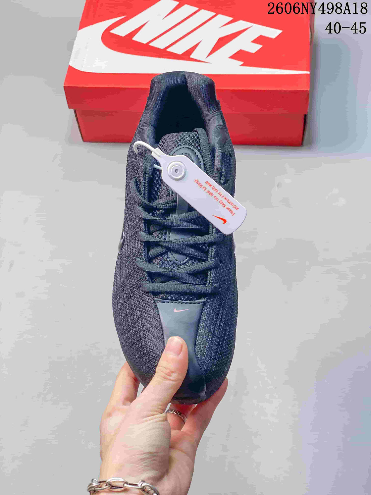 Top view of a charcoal Nike Shox TL sneaker with laces and red accents.