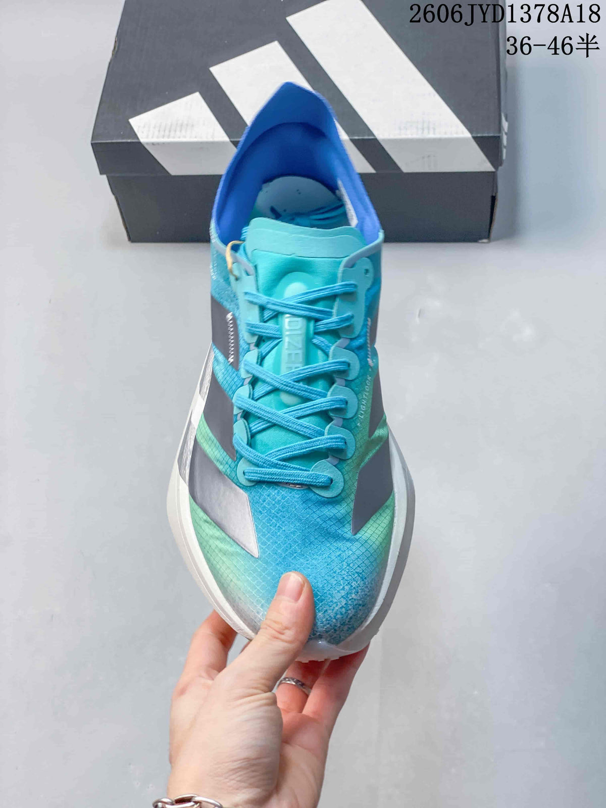 Front view showing the laces, tongue and patterned blue upper