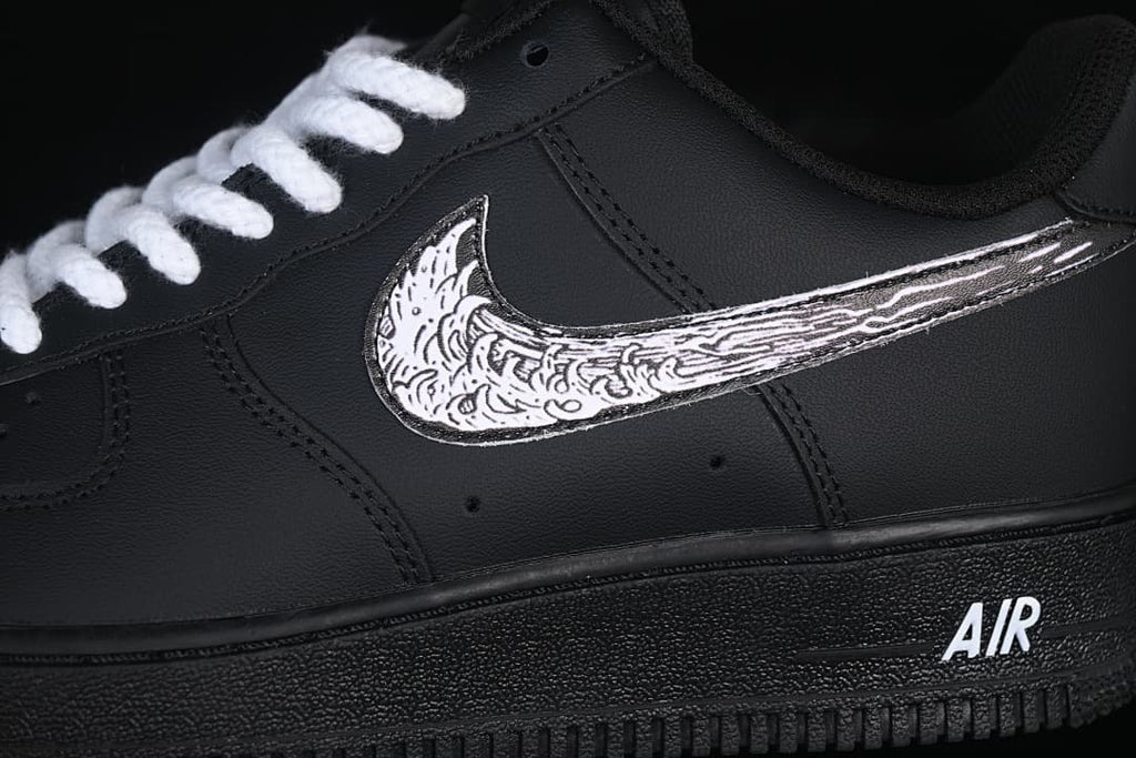 Close-up of the illustrated Swoosh and white AIR lettering on the midsole
