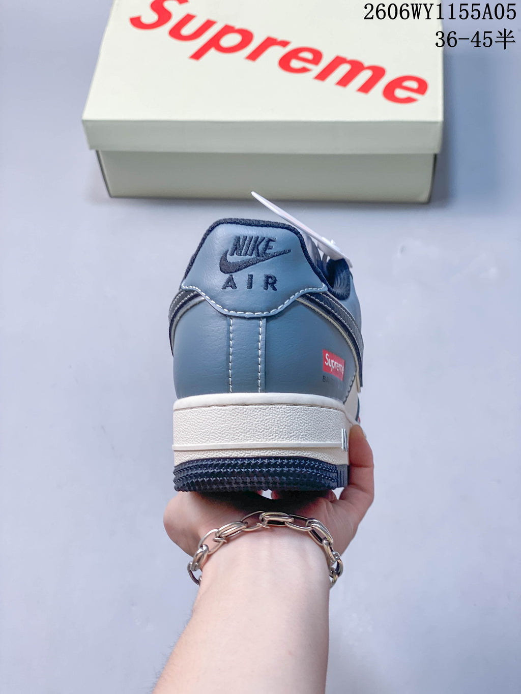 Rear view showing the blue heel, white midsole and branded heel details.