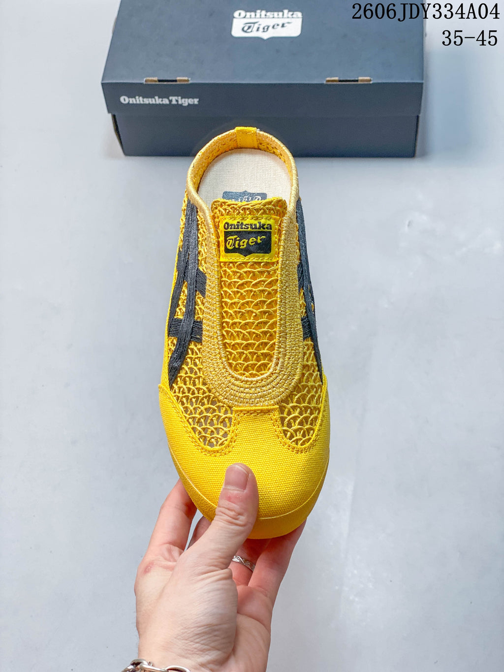 Top view of the yellow slip-on showing its woven-look upper and rounded toe.